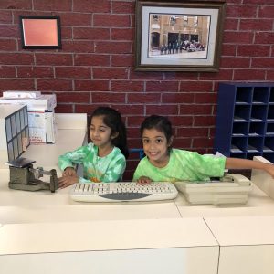Kindergarten students being post office workers at INK